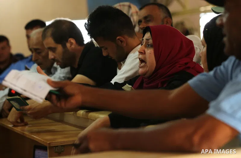 Palestinians wait for travel permits to cross into Egypt through the Rafah border crossing after it was opened by Egyptian authorities for humanitarian cases, in Rafah in the southern Gaza Strip on August 16, 2017. Photo...