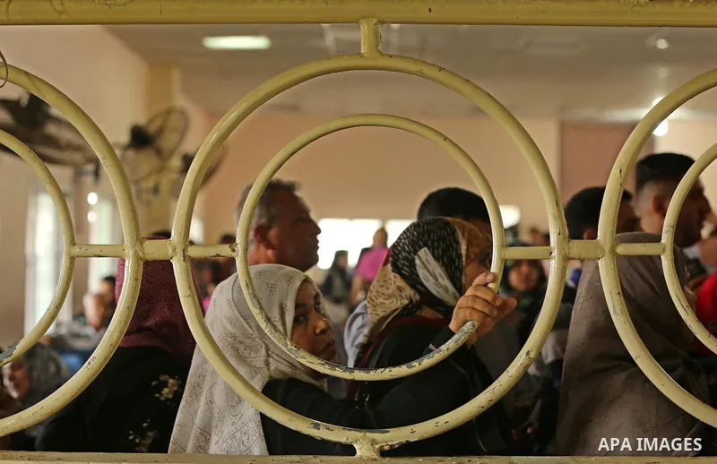 Palestinians wait for travel permits to cross into Egypt through the Rafah border crossing after it was opened by Egyptian authorities for humanitarian cases, in Rafah in the southern Gaza Strip on August 16, 2017. Photo...
