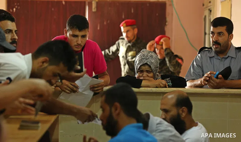 Palestinians wait for travel permits to cross into Egypt through the Rafah border crossing after it was opened by Egyptian authorities for humanitarian cases, in Rafah in the southern Gaza Strip on August 16, 2017. Photo...