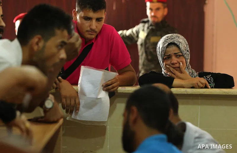Palestinians wait for travel permits to cross into Egypt through the Rafah border crossing after it was opened by Egyptian authorities for humanitarian cases, in Rafah in the southern Gaza Strip on August 16, 2017. Photo...