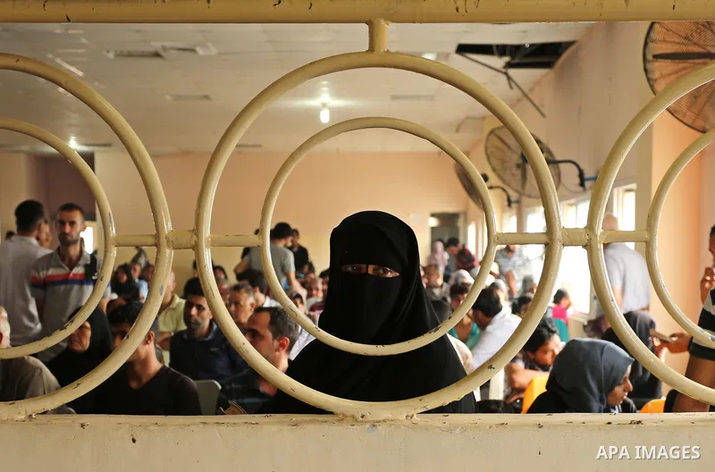 Palestinians wait for travel permits to cross into Egypt through the Rafah border crossing after it was opened by Egyptian authorities for humanitarian cases, in Rafah in the southern Gaza Strip on August 16, 2017. Photo...