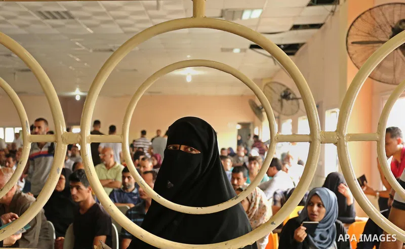 Palestinians wait for travel permits to cross into Egypt through the Rafah border crossing after it was opened by Egyptian authorities for humanitarian cases, in Rafah in the southern Gaza Strip on August 16, 2017. Photo...