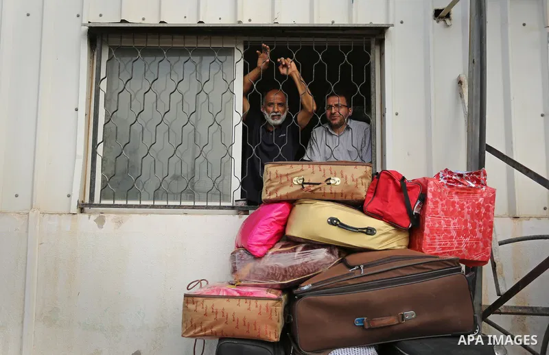 Palestinians wait for travel permits to cross into Egypt through the Rafah border crossing after it was opened by Egyptian authorities for humanitarian cases, in Rafah in the southern Gaza Strip on August 16, 2017. Photo...