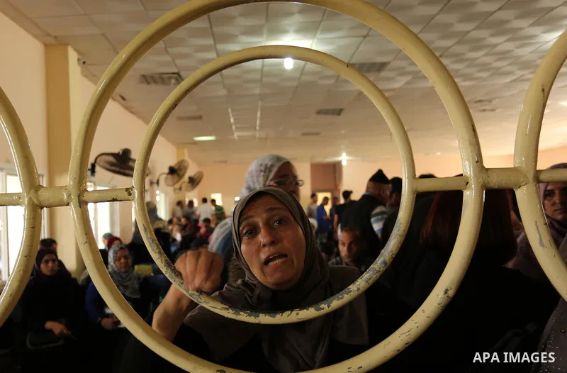 Palestinians wait for travel permits to cross into Egypt through the Rafah border crossing after it was opened by Egyptian authorities for humanitarian cases, in Rafah in the southern Gaza Strip on August 16, 2017. Photo...
