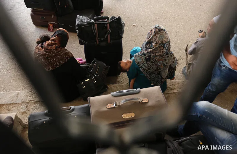Palestinians wait for travel permits to cross into Egypt through the Rafah border crossing after it was opened by Egyptian authorities for humanitarian cases, in Rafah in the southern Gaza Strip on August 16, 2017. Photo...