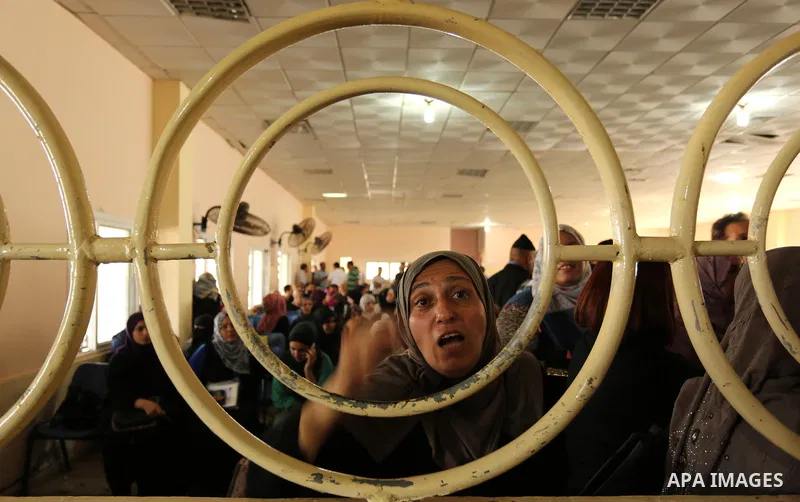 Palestinians wait for travel permits to cross into Egypt through the Rafah border crossing after it was opened by Egyptian authorities for humanitarian cases, in Rafah in the southern Gaza Strip on August 16, 2017. Photo...