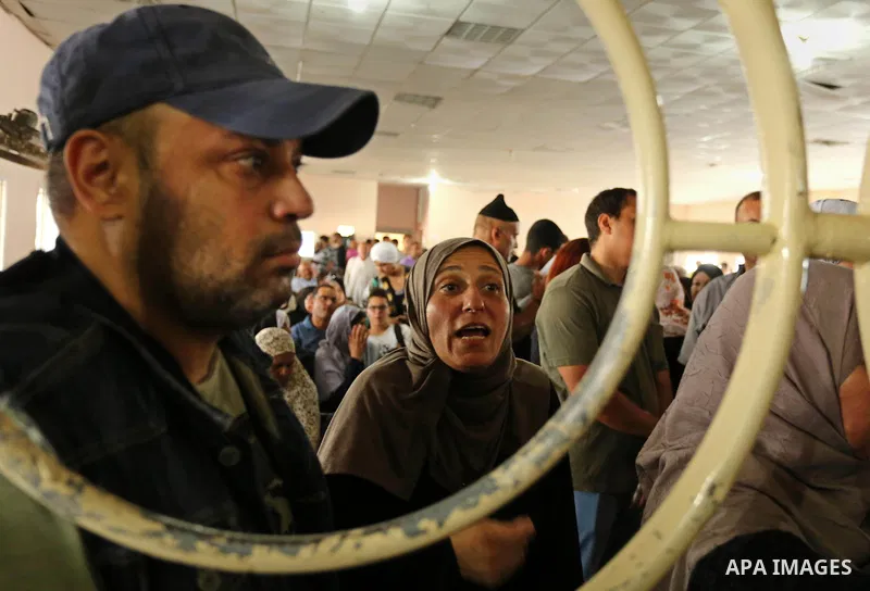 Palestinians wait for travel permits to cross into Egypt through the Rafah border crossing after it was opened by Egyptian authorities for humanitarian cases, in Rafah in the southern Gaza Strip on August 16, 2017. Photo...
