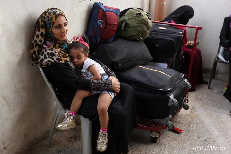 Palestinians wait for travel permits to cross into Egypt through the Rafah border crossing after it was opened by Egyptian authorities for humanitarian cases, in Rafah in the southern Gaza Strip on August 16, 2017. Photo...