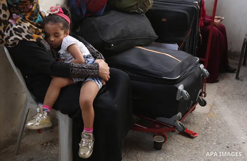 Palestinians wait for travel permits to cross into Egypt through the Rafah border crossing after it was opened by Egyptian authorities for humanitarian cases, in Rafah in the southern Gaza Strip on August 16, 2017. Photo...