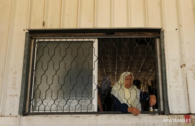 Palestinians wait for travel permits to cross into Egypt through the Rafah border crossing after it was opened by Egyptian authorities for humanitarian cases, in Rafah in the southern Gaza Strip on August 16, 2017. Photo...
