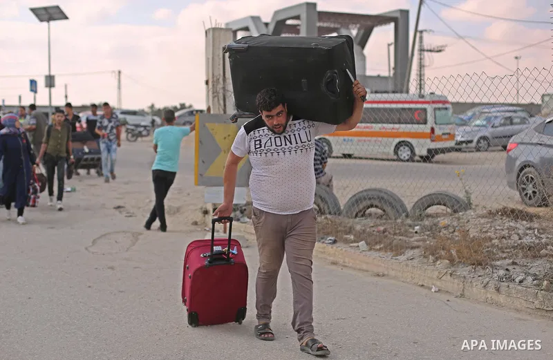 Palestinians wait for travel permits to cross into Egypt through the Rafah border crossing after it was opened by Egyptian authorities for humanitarian cases, in Rafah in the southern Gaza Strip on August 16, 2017. Photo...