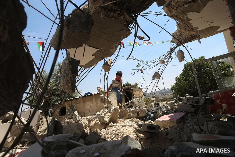 A boy walks next to the remains of the family house of Palestinian assailant Omar Alabed after it was demolished by Israeli troops in the West Bank village of Khobar near Ramallah August 16, 2017. Photo by Shadi Hatem