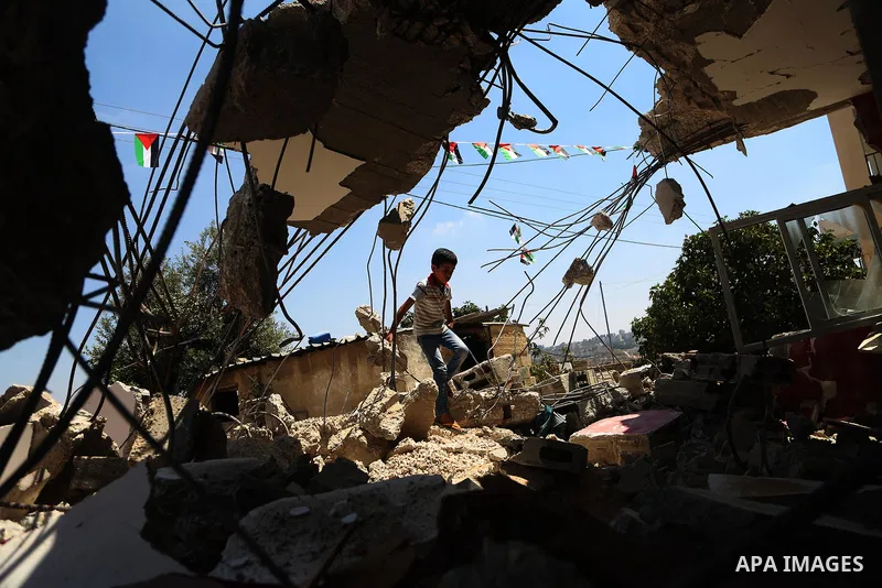 A boy walks next to the remains of the family house of Palestinian assailant Omar Alabed after it was demolished by Israeli troops in the West Bank village of Khobar near Ramallah August 16, 2017. Photo by Shadi Hatem