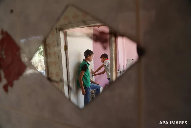 People check the remains of the house of a Palestinian man, who killed three Jewish residents of a nearby Israeli settlement, after it was demolished by Israeli authorities in the West Bank village of Kobar, near Ramalla...