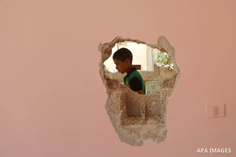 A boy walks next to the remains of the family house of Palestinian assailant Omar Alabed after it was demolished by Israeli troops in the West Bank village of Khobar near Ramallah August 16, 2017. Photo by Shadi Hatem