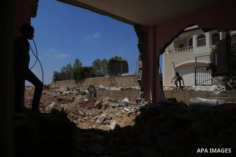 A boy walks next to the remains of the family house of Palestinian assailant Omar Alabed after it was demolished by Israeli troops in the West Bank village of Khobar near Ramallah August 16, 2017. Photo by Shadi Hatem