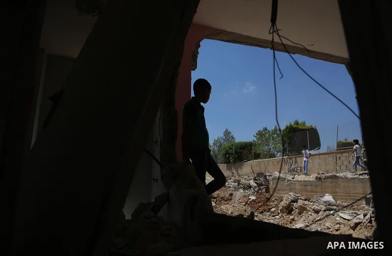 A boy walks next to the remains of the family house of Palestinian assailant Omar Alabed after it was demolished by Israeli troops in the West Bank village of Khobar near Ramallah August 16, 2017. Photo by Shadi Hatem
