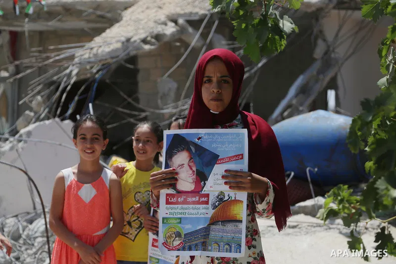People check the remains of the house of a Palestinian man, who killed three Jewish residents of a nearby Israeli settlement, after it was demolished by Israeli authorities in the West Bank village of Kobar, near Ramalla...