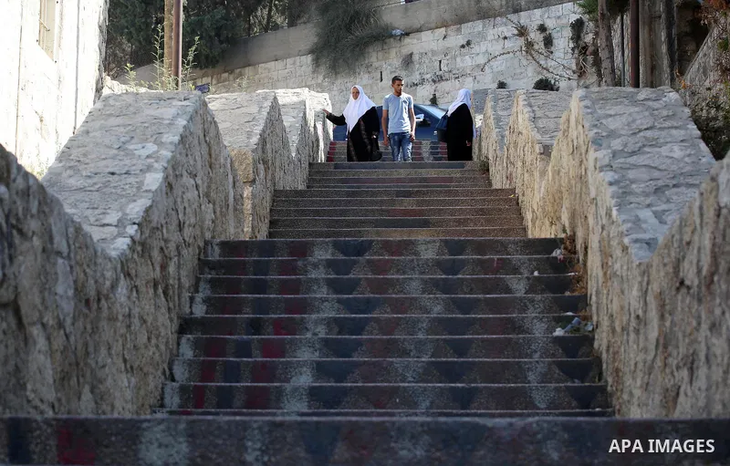 Palestinians walk down stairs to reach the markets in the Old city of the West Bank city of Nablus on August 17, 2017. Nablus city is located between two mountains where hundreds of houses are built to face the increase...