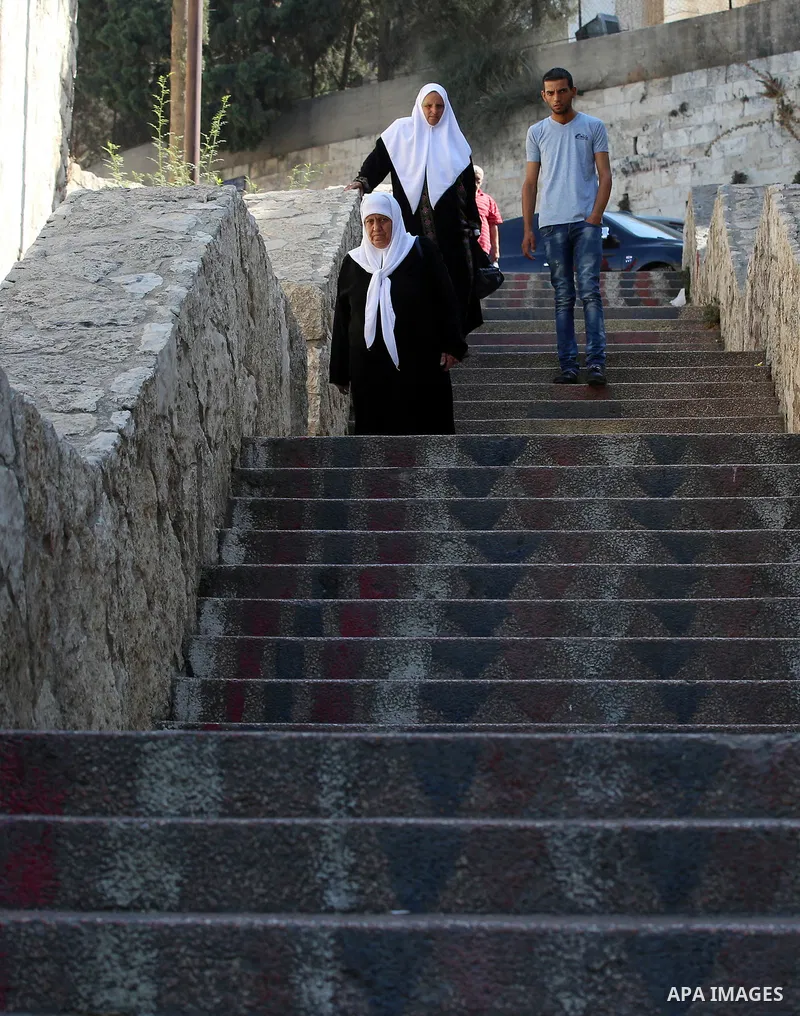 Palestinians walk down stairs to reach the markets in the Old city of the West Bank city of Nablus on August 17, 2017. Nablus city is located between two mountains where hundreds of houses are built to face the increase...