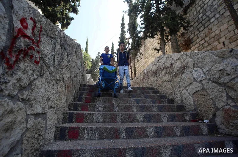 Palestinians walk down stairs to reach the markets in the Old city of the West Bank city of Nablus on August 17, 2017. Nablus city is located between two mountains where hundreds of houses are built to face the increase...