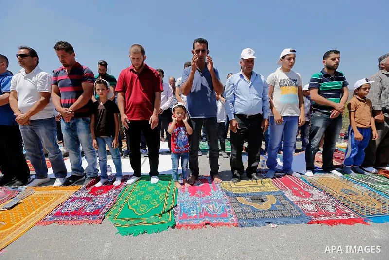 Palestinians take part in Friday prayer before a protest against alerts of the Israeli army to demolish houses, in the West Bank village of Walajeh, near Bethlehem, August 18, 2017. Photo by Wisam Hashlamoun