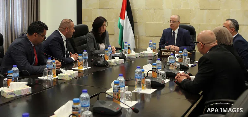 Palestinian Prime Minister, Rami Hamdallah, meets Minister of Justice Ali Abu Diak at his office, in the West Bank city of Ramallah on August 20, 2017. Photo by Prime Minister Office