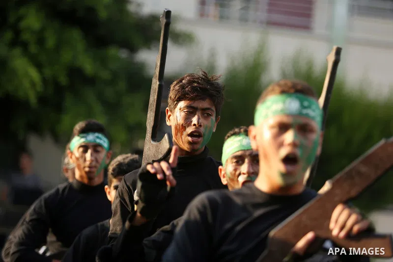 Palestinian youths take part in a military graduation ceremony at a Hamas summer camp in al-Bureij in the central of Gaza strip, August 20, 2017. Photo by Ashraf Amra