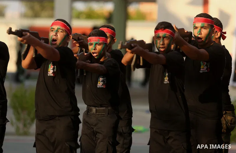 Palestinian youths take part in a military graduation ceremony at a Hamas summer camp in al-Bureij in the central of Gaza strip, August 20, 2017. Photo by Ashraf Amra
