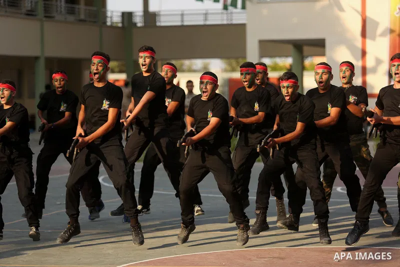 Palestinian youths take part in a military graduation ceremony at a Hamas summer camp in al-Bureij in the central of Gaza strip, August 20, 2017. Photo by Ashraf Amra