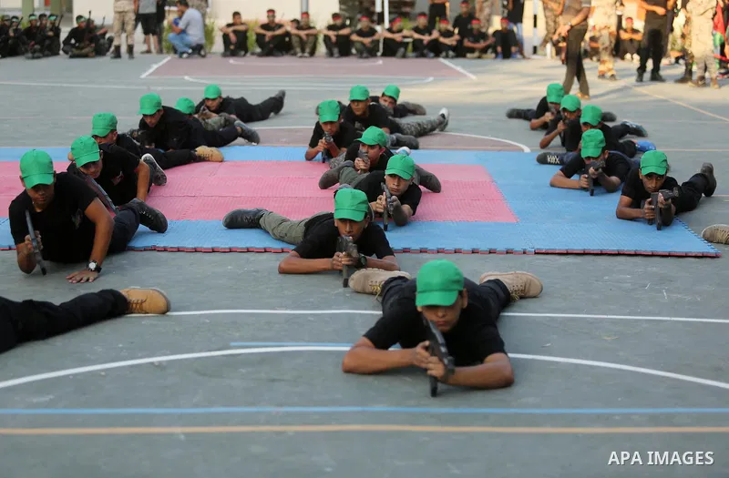 Palestinian youths take part in a military graduation ceremony at a Hamas summer camp in al-Bureij in the central of Gaza strip, August 20, 2017. Photo by Ashraf Amra