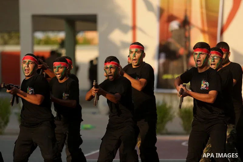 Palestinian youths take part in a military graduation ceremony at a Hamas summer camp in al-Bureij in the central of Gaza strip, August 20, 2017. Photo by Ashraf Amra