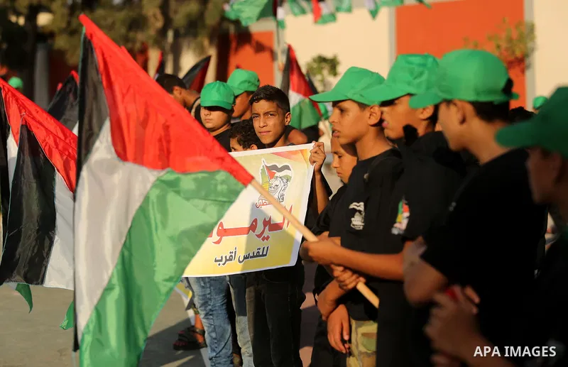 Palestinian youths take part in a military graduation ceremony at a Hamas summer camp in al-Bureij in the central of Gaza strip, August 20, 2017. Photo by Ashraf Amra
