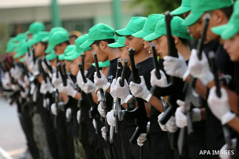 Palestinian youths take part in a military graduation ceremony at a Hamas summer camp in al-Bureij in the central of Gaza strip, August 20, 2017. Photo by Ashraf Amra