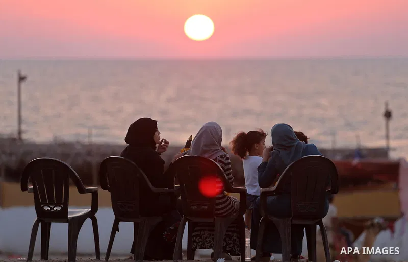 Palestinians enjoy a day at the beach of the Mediterranean sea in Gaza city during sunset, on August 20, 2017. Photo by Ashraf Amra