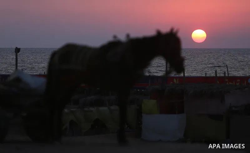 The sunset is seen from the beach of the Mediterranean Sea in Gaza City, on August 20, 2017. Photo by Ashraf Amra