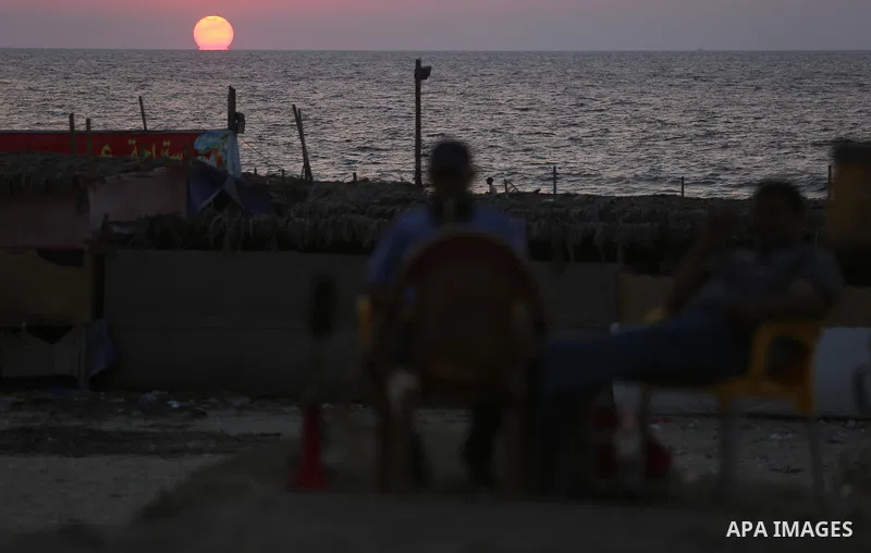 The sunset is seen from the beach of the Mediterranean Sea in Gaza City, on August 20, 2017. Photo by Ashraf Amra