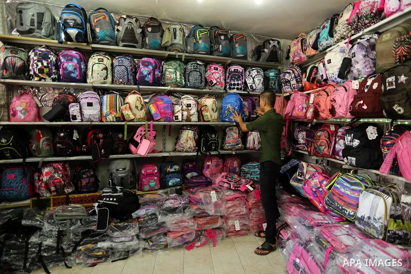 Palestinians shop during preparation for the new school year at a market in Gaza city, on August 21, 2017. Photo by Ashraf Amra
