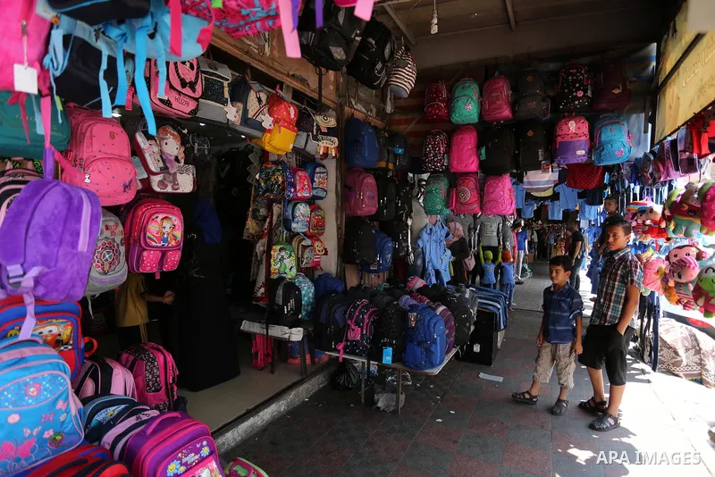 Palestinians shop during preparation for the new school year at a market in Gaza city, on August 21, 2017. Photo by Ashraf Amra