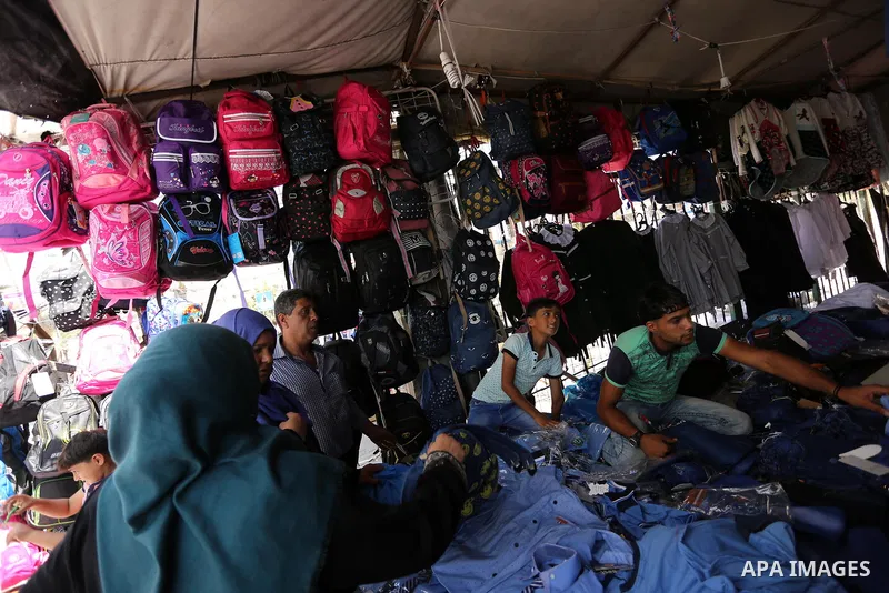 Palestinians shop during preparation for the new school year at a market in Gaza city, on August 21, 2017. Photo by Ashraf Amra