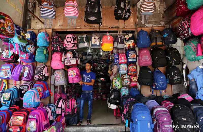 Palestinians shop during preparation for the new school year at a market in Gaza city, on August 21, 2017. Photo by Ashraf Amra