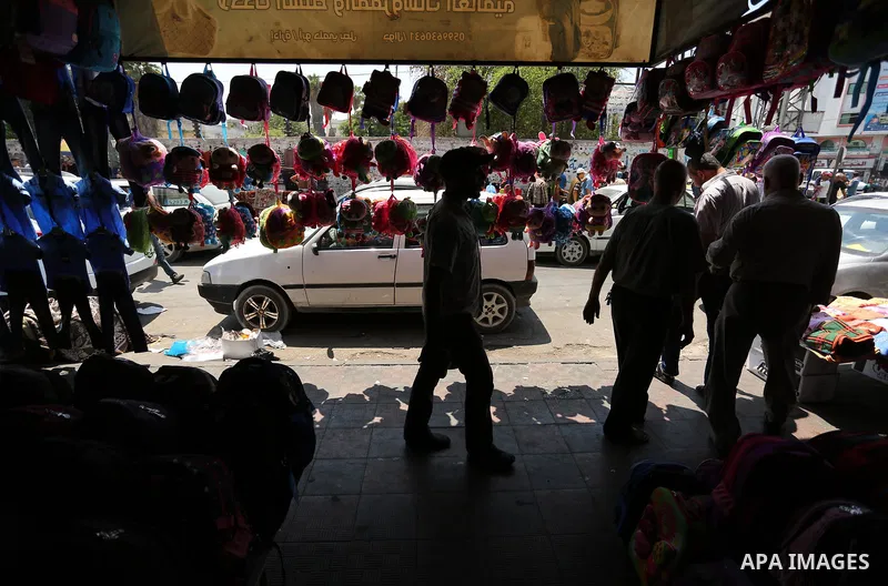 Palestinians shop during preparation for the new school year at a market in Gaza city, on August 21, 2017. Photo by Ashraf Amra