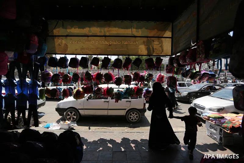 Palestinians shop during preparation for the new school year at a market in Gaza city, on August 21, 2017. Photo by Ashraf Amra