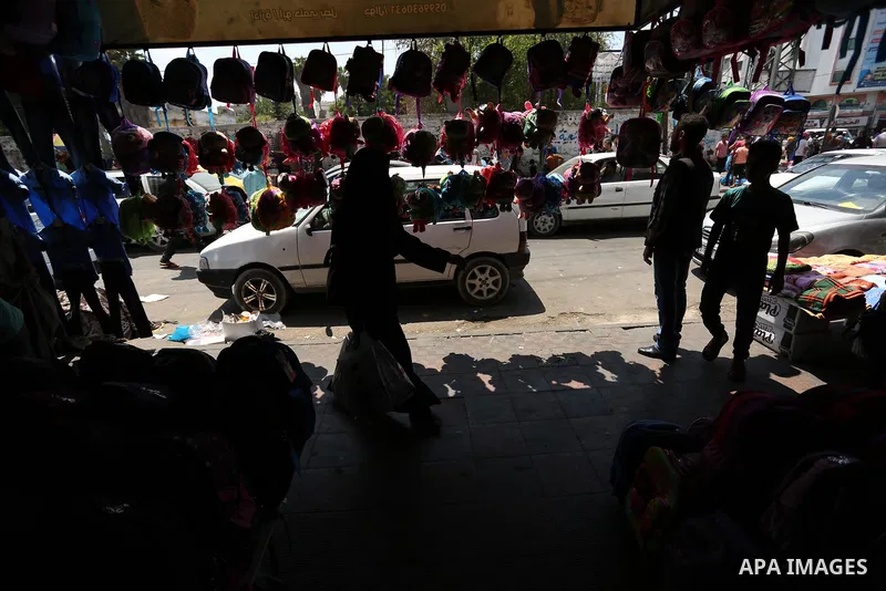 Palestinians shop during preparation for the new school year at a market in Gaza city, on August 21, 2017. Photo by Ashraf Amra