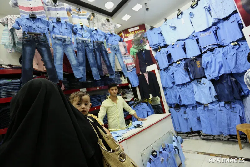 Palestinians shop during preparation for the new school year at a market in Gaza city, on August 21, 2017. Photo by Ashraf Amra