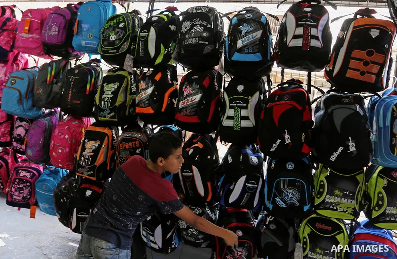 Palestinians shop during preparation for the new school year at a market in Gaza city, on August 21, 2017. Photo by Ashraf Amra