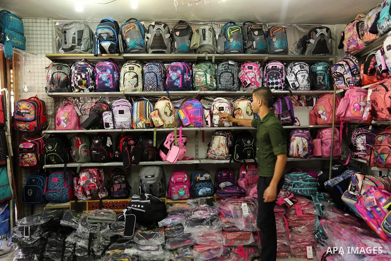Palestinians shop during preparation for the new school year at a market in Gaza city, on August 21, 2017. Photo by Ashraf Amra