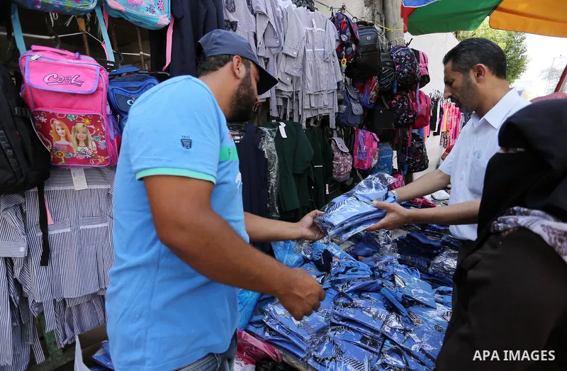 Palestinians shop during preparation for the new school year at a market in Gaza city, on August 21, 2017. Photo by Ashraf Amra