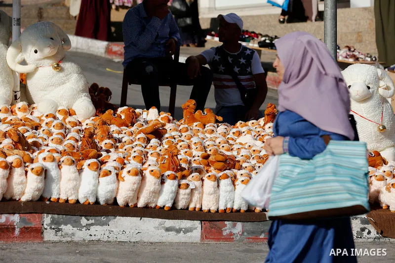 A Palestinian vendor displays toys of sheep at a market ahead of the Eid al-Adha festival in the West Bank city of Hebron, on August 21, 2017. Photo by Wisam Hashlamoun