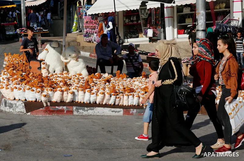 A Palestinian vendor displays toys of sheep at a market ahead of the Eid al-Adha festival in the West Bank city of Hebron, on August 21, 2017. Photo by Wisam Hashlamoun